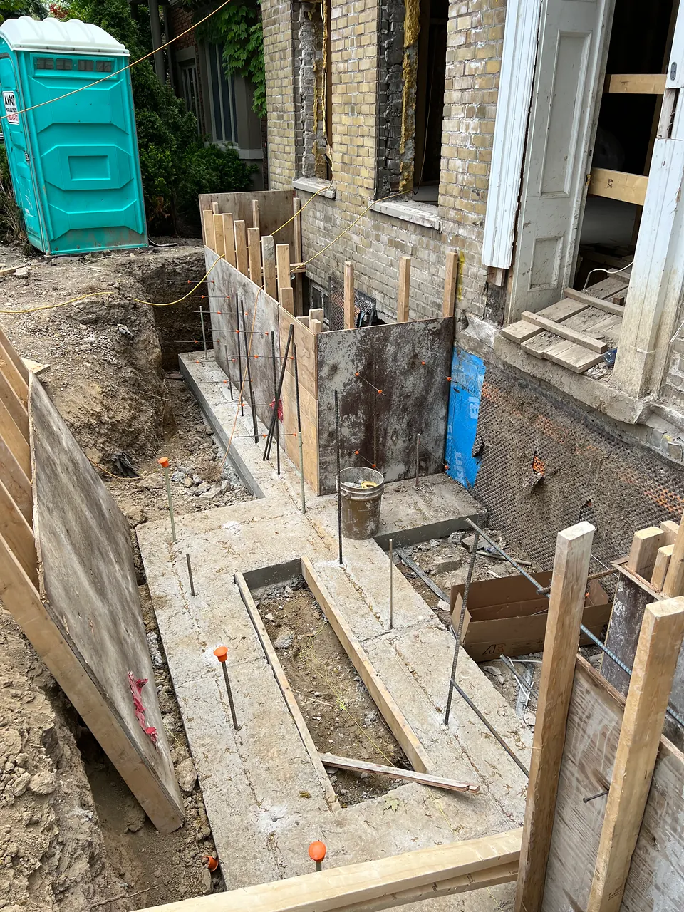 Underpinning beside an existing house
