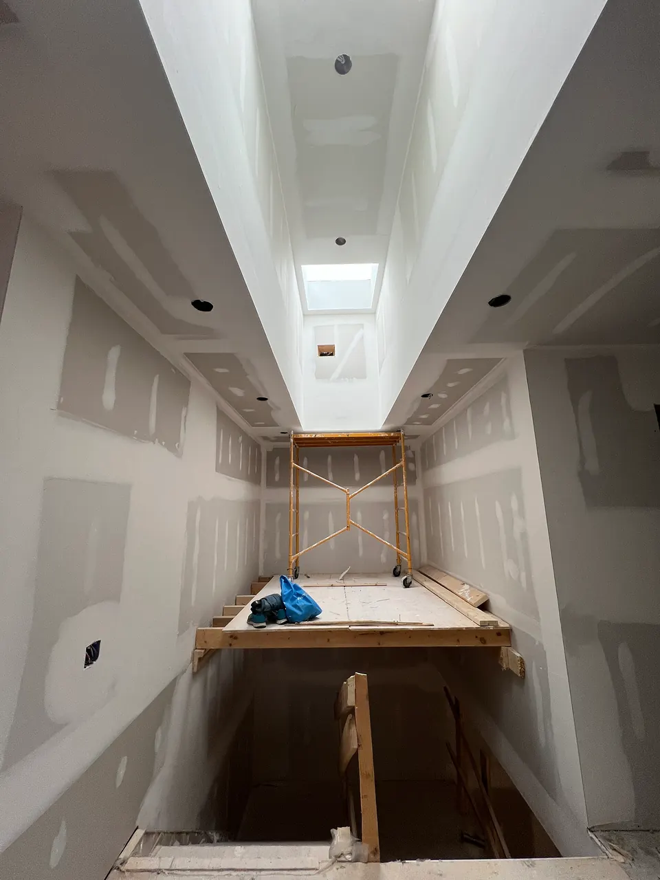 Stair hall under a skylight at drywall stage