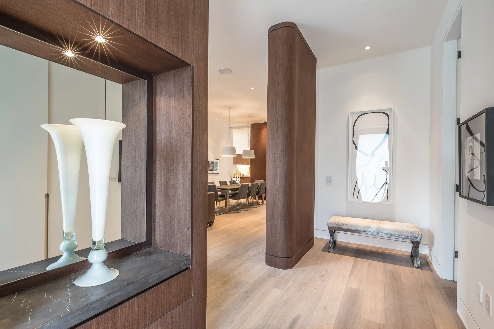 Entry with a walnut wall and sculpture niche
