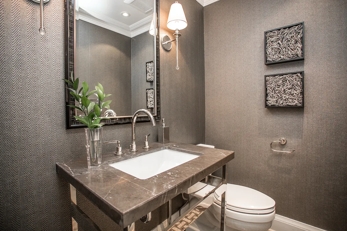 Powder room with a stone console sink