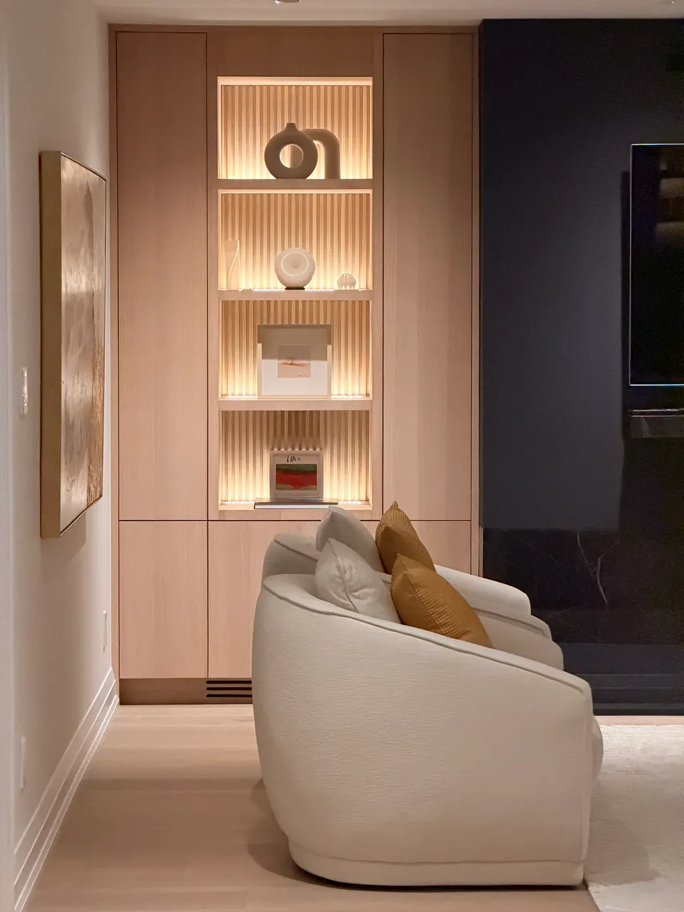 Lit shelving in a lounge alcove